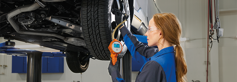 A Subaru technician checking tire pressure. | Randy Marion Subaru in Mooresville NC